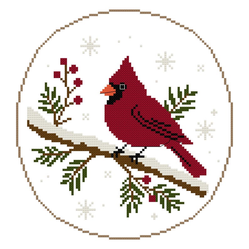 May include: A circular cross-stitch pattern featuring a vibrant red cardinal bird perched on a brown branch covered in white snow. The design includes dark green pine needles, small red berries, and light gray snowflakes on a white background.