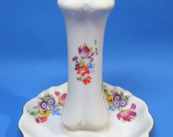 May include: White porcelain vase with a scalloped rim and a matching base. The vase and base are decorated with colourful floral patterns and gold trim. The vase is approximately 15 cm tall.