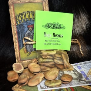 May include: A green card with the text "Mojo Beans" and "Make wishes come true with African Wishing Beans". A bag of brown beans is on a tarot card with the text "Nine of Cups" and "Wish Fulfilled".