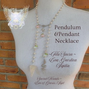 May include: A silver-toned pendulum and pendant necklace with a geometric crystal pendant and a snake charm. The necklace features pink and green beaded accents and the text "Pendulum & Pendant Necklace".