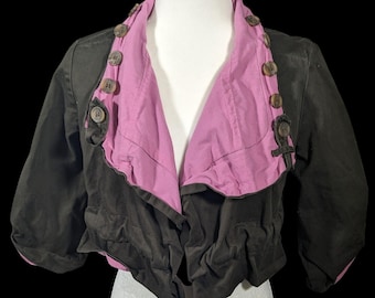 May include: A black and purple cropped jacket with a ruffled hem and wooden buttons.