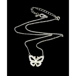 May include: A silver chain necklace with a sparkling butterfly pendant. The butterfly is made of silver and has clear rhinestones.
