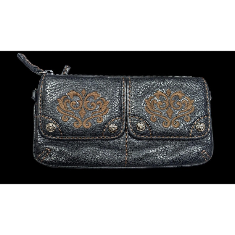 May include: A black leather clutch with a zipper closure and two front pockets. The pockets have brown embroidered floral designs and silver studs.