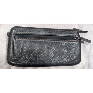 May include: A black leather wallet with two zippered compartments and a brown stitch detail.