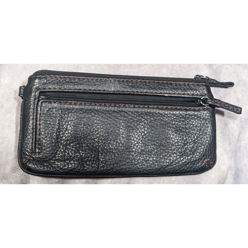 May include: A black leather wallet with two zippered compartments and a brown stitch detail.