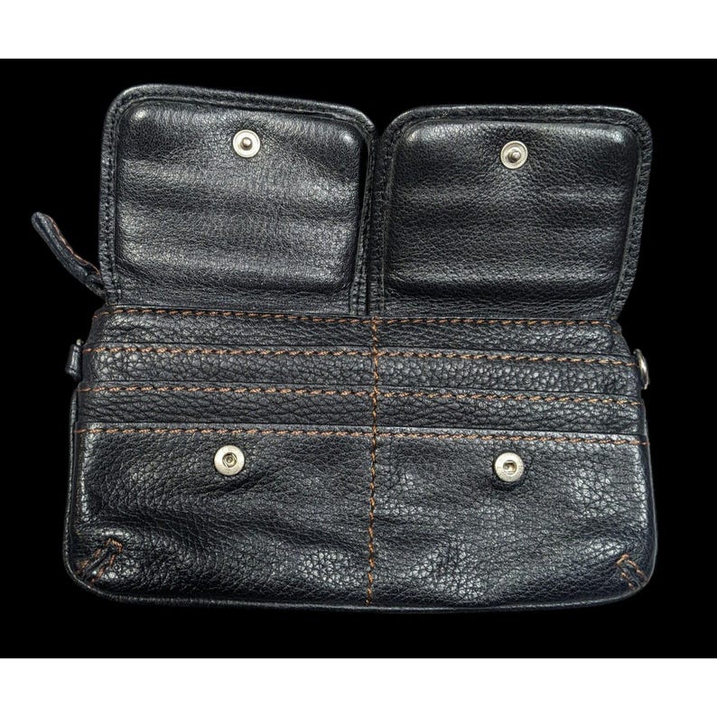 May include: Black leather wallet with multiple card slots and a zipper closure. The wallet has two separate compartments with snap closures.