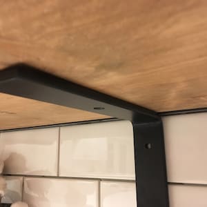 Metal L shape bracket supporting shelf board