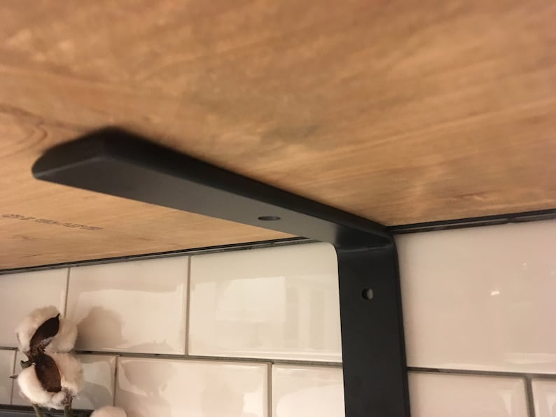 Metal L shape bracket supporting shelf board