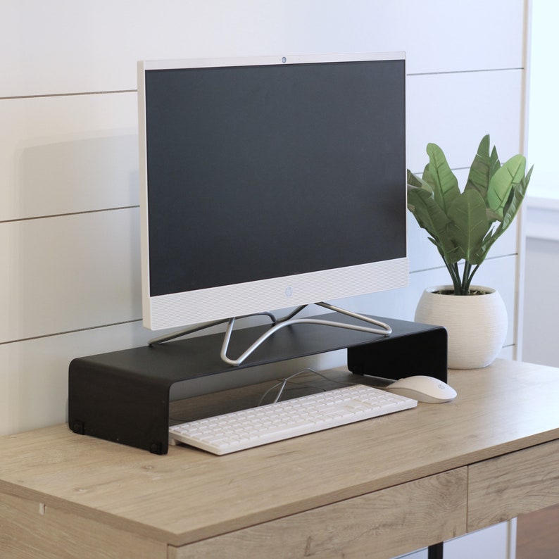 A black metal monitor riser or stand