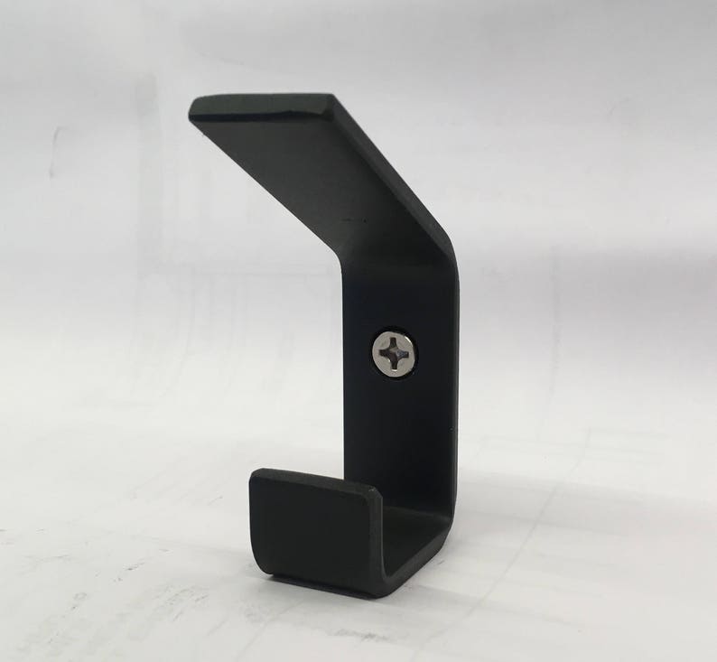 May include: A black metal hook with a single screw. The hook is shaped like a 'J' and has a rounded end.
