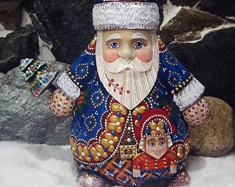 Santa Claus in his blue coat with a small tree. Carved wooden statuette. Wooden Santa Claus. Ded Moroz (Ref:PN19B3)