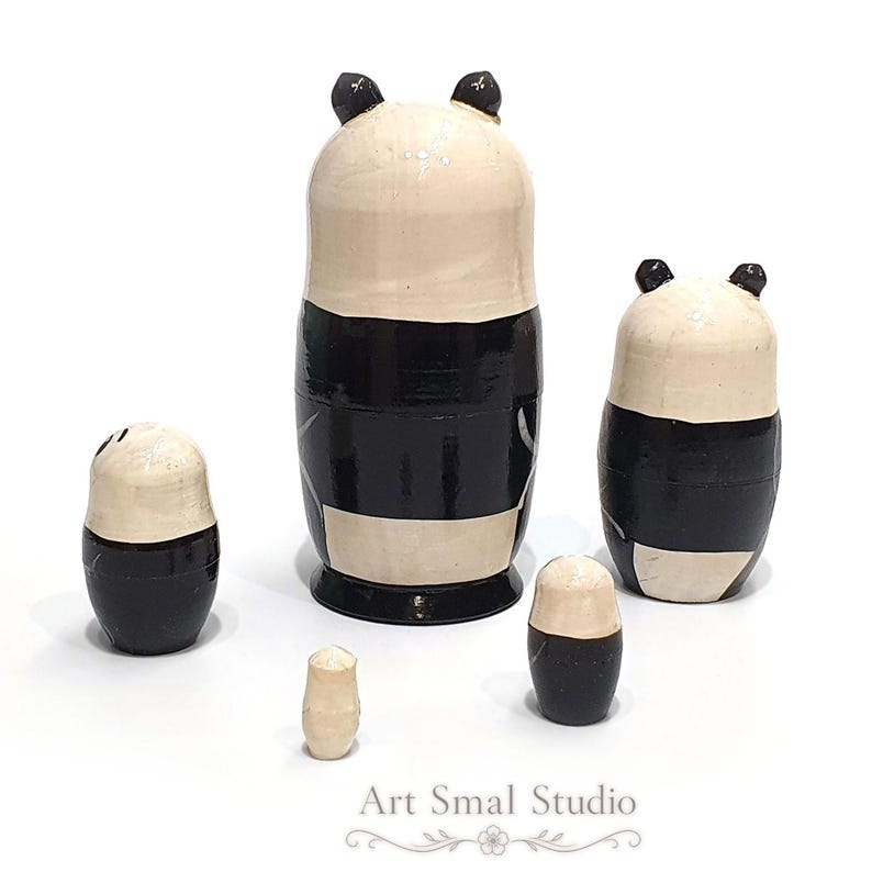 Back view of a five-piece panda matryoshka nesting doll set, with the Russian wooden dolls displayed separately to show their rear sides and overall shapes against a clean white background