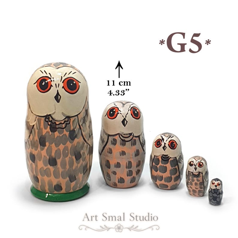 May include: A set of five nesting dolls shaped like owls, featuring orange eyes and brown and gray speckled plumage. The largest doll is 11 cm tall. The text *G5* appears in the upper right corner, and Art Smal Studio is printed at the bottom.