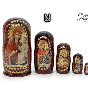 May include: A set of five Russian nesting dolls, each with a burgundy finish and gold accents. The dolls feature religious iconography, with images of the Virgin Mary and child. The largest doll is 10.5 cm (4.13 inches) tall.