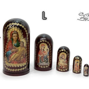 May include: A set of five dark brown nesting dolls, each featuring a religious icon with gold accents. The largest doll is 4.33 inches tall. The dolls are arranged from largest to smallest.