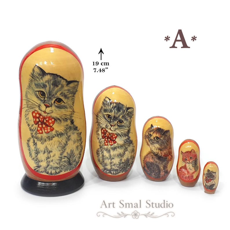 Gray cat hand painted on a Russian nesting doll set displayed from largest to smallest, featuring adorable kitten artwork, glossy wooden craftsmanship and a white background with size reference