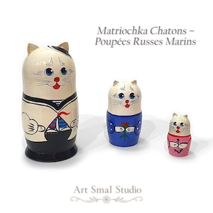 Set of 3 hand-painted cat sailor matryoshka dolls, 11 cm tall, displayed on a white background: a white and black sailor cat, a white and blue cat, and a white and pink cat
