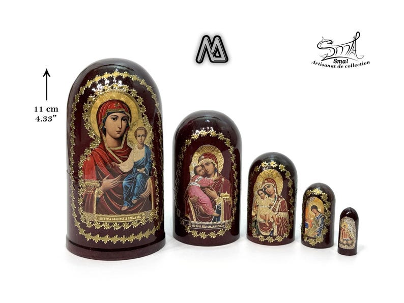 May include: A set of five nesting dolls, each featuring religious iconography. The largest doll is 4.33 inches tall and the dolls are painted in shades of red, gold, and blue. The dolls have a glossy finish and are arranged in a row.
