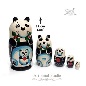 5-piece panda matryoshka nesting doll set, handmade Russian wooden dolls in graduated sizes. The largest panda nesting doll measures 11 cm (4.33 inches), with smaller dolls arranged beside it on a white background