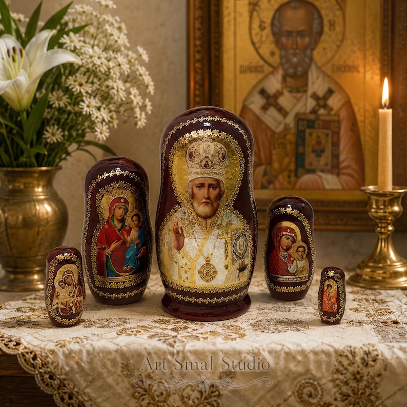 Russian Orthodox Matryoshka set of 5 with Saint Nicholas and sacred icons, hand-painted wooden nesting dolls displayed on an embroidered tablecloth