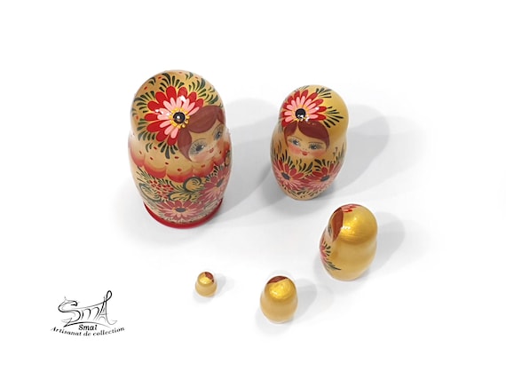 金色のロシアの入れ子人形5体セット。手描きの木製マトリョーシカに花