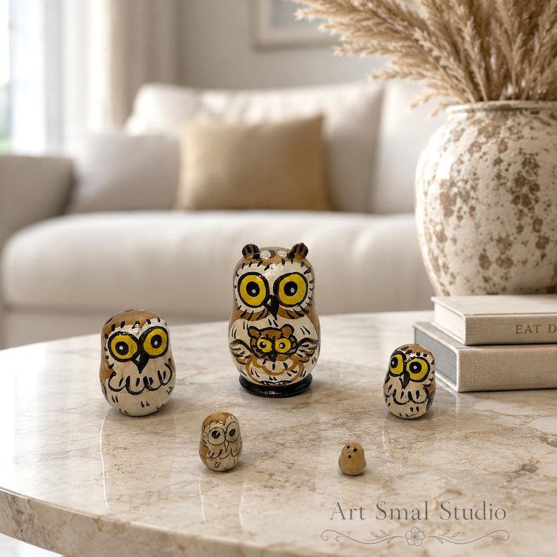 Hand-painted owl nesting dolls, five-piece Russian matryoshka set with tiny inner dolls, one of the world’s smallest matryoshka dolls, displayed on a marble table in a bright elegant living room