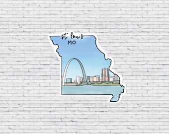 May include: A sticker of the state of Missouri with a blue sky and the Gateway Arch in St. Louis, MO.