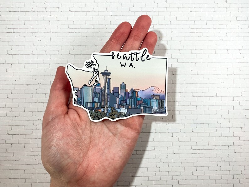 May include: A sticker of the Seattle skyline with the Space Needle, Mount Rainier, and the text "Seattle WA."