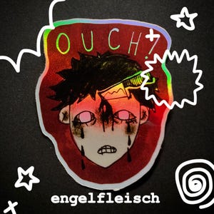 May include: Holographic sticker featuring a distressed cartoon face with the word "OUCH?" in green and the word "engelfleisch" in black. The sticker has a red background with white accents and a black background.
