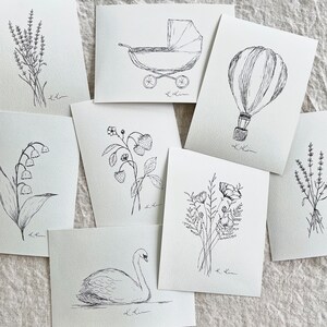 May include: A set of ten black and white illustrations featuring various subjects, including a baby carriage, a hot air balloon, a swan, flowers, and a sprig of lavender. Each illustration is drawn in a simple, minimalist style and is perfect for adding a touch of whimsy to any project.