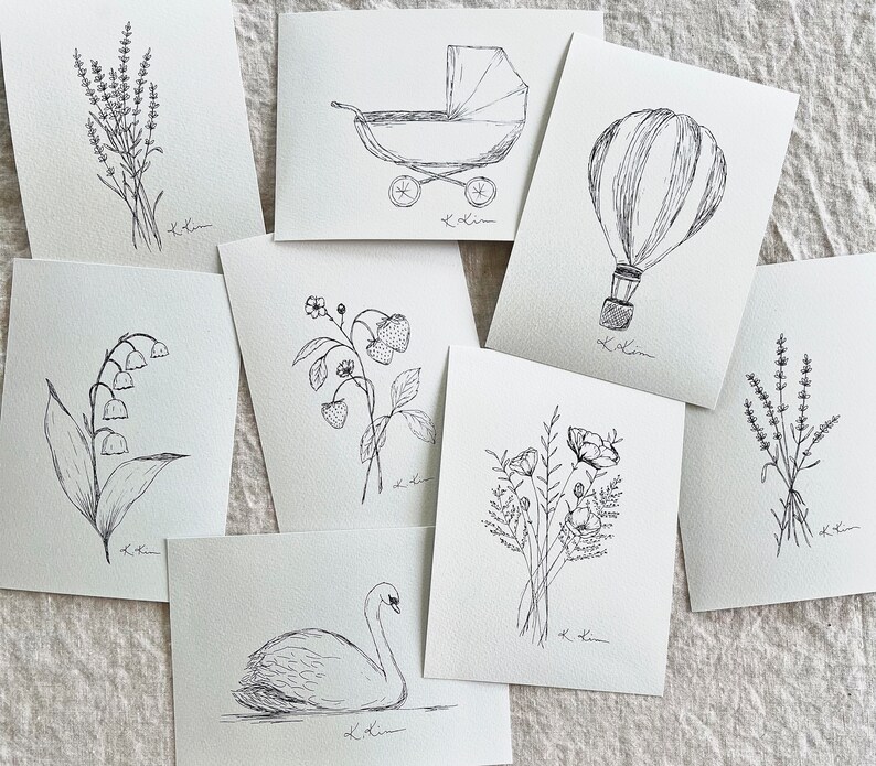May include: A set of ten black and white illustrations featuring various subjects, including a baby carriage, a hot air balloon, a swan, flowers, and a sprig of lavender. Each illustration is drawn in a simple, minimalist style and is perfect for adding a touch of whimsy to any project.
