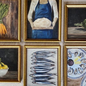 May include: A collection of six framed paintings, each depicting a different still life. The paintings are arranged in a grid pattern on a wall. The paintings include a bunch of carrots, a person holding a loaf of bread, an artichoke, a bowl of lemons, a row of fish, and a plate of oysters.