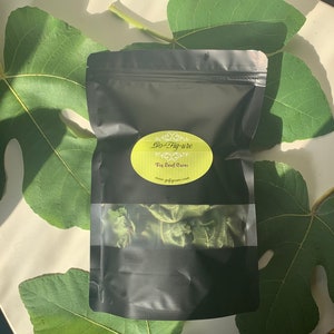 May include: A black resealable bag with a clear window showing dried fig leaves inside. The bag has a white label with the text "Go-Fig-ure Fig Leaf Cures www.gofigure.com".