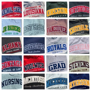 May include: A collage of 16 different sweatshirt designs featuring various college and university names. The sweatshirts are in a variety of colours, including red, blue, green, grey, and beige. Each sweatshirt has a different design, with some featuring the school's name in a bold, arched font, while others have more intricate designs.