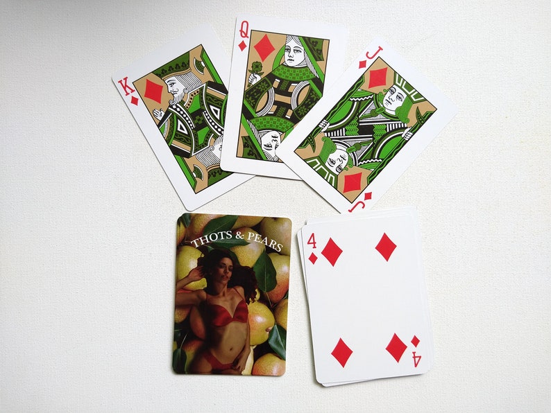 May include: A set of playing cards featuring a queen, jack, king, and four of diamonds. The cards have a green and gold design with a person's face on each card. The four of diamonds card has a red background with four red diamonds.