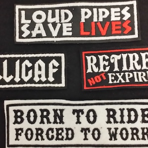 May include: Four black and white embroidered patches with white text on a black background. The patches read "Loud Pipes Save Lives", "Dilligaf", "Retired Not Expired", and "Born To Ride Forced To Work".