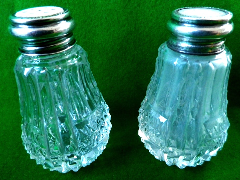 2 mother of pearl and silver top salt and pepper pots with glass bases
