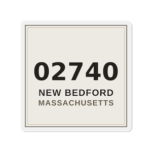 May include: A square sticker with a light beige background and a thin black border. The text 02740 is printed in large black font, followed by NEW BEDFORD in black and MASSACHUSETTS in a smaller gray font below it.