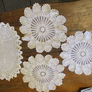 Four White Crocheted Doilies