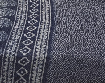 May include: A dark blue fabric with a white geometric pattern. The fabric has a border with a paisley design.