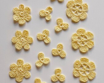 A set of yellow knitted items for creativity / needlework / decor for clothes. Applications in yellow (lemon) color flowers
