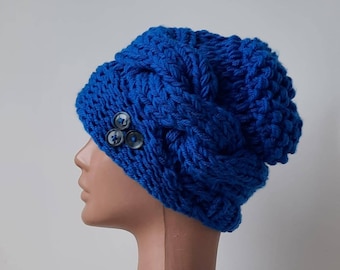 A warm winter hat. Chunky cap with buttons. A blue knitted hat for her. Thick winter hat. The cable is knitted for ear warmth.