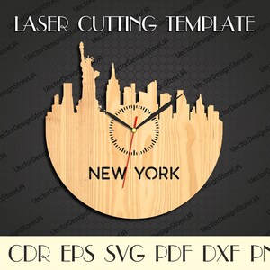 May include: A wooden laser cutting template of a New York City skyline clock. The clock features the Statue of Liberty and city buildings. The clock hands are black, and the second hand is red. The text "NEW YORK" is below the clock face. The words "LASER CUTTING TEMPLATE" are at the top.