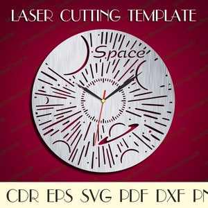May include: A silver clock face with a laser cut design of planets, stars, and the word "Space". The clock face is on a red background.