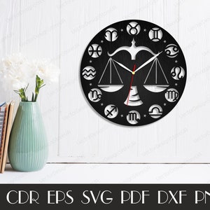 May include: Black and white clock with a Libra zodiac symbol in the centre and all 12 zodiac symbols around the edge. The clock hands are black and white.