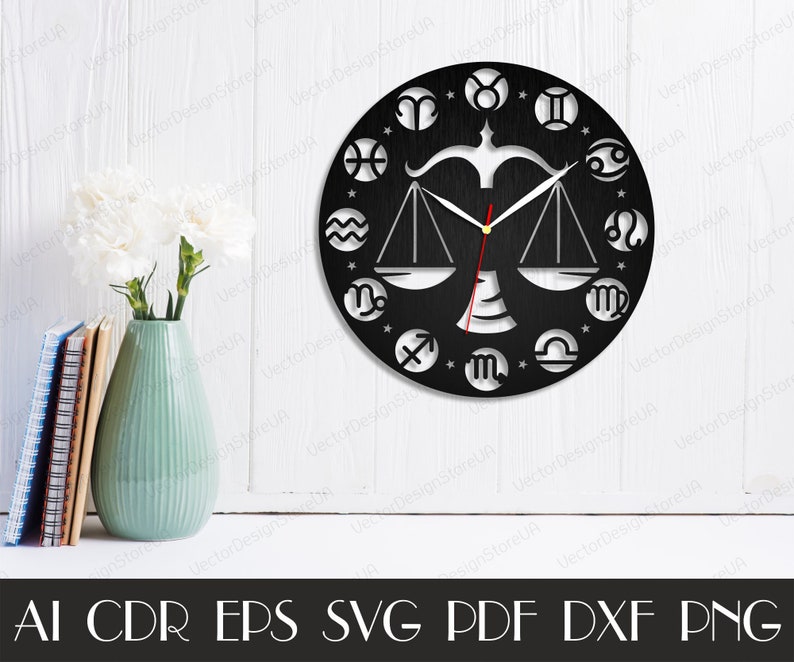 May include: Black and white clock with a Libra zodiac symbol in the centre and all 12 zodiac symbols around the edge. The clock hands are black and white.