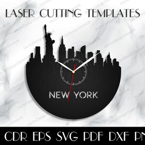 May include: Black laser-cut clock featuring the New York City skyline, including the Statue of Liberty. The clock face displays the text "NEW YORK" and the words "LASER CUTTING TEMPLATES" at the top. Includes AI, CDR, EPS, SVG, PDF, DXF, and PNG file formats.