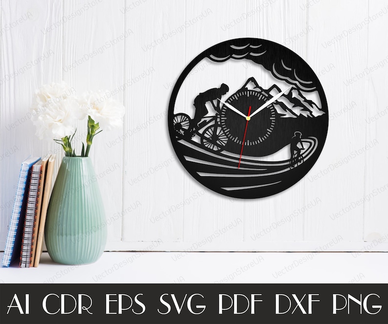 May include: Black and white silhouette of a mountain biker riding downhill with a clock face in the background. The clock face has a red hour hand and a black minute hand. The design is suitable for a wall clock.