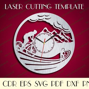 May include: A laser cut template design for a clock featuring a cyclist riding a mountain bike up a hill with a mountain range in the background. The clock face is in the center of the design. The template is available in AI, CDR, EPS, SVG, PDF, DXF, and PNG formats.