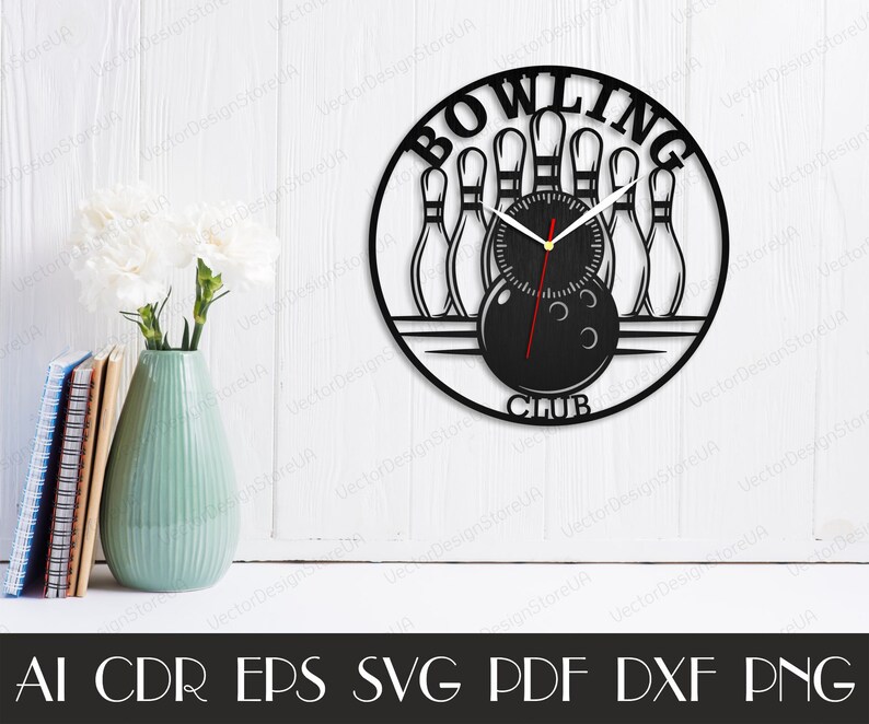 May include: Black laser-cut wall clock with a bowling theme. The clock features bowling pins, a bowling ball, and the words "BOWLING CLUB." The clock hands are black with a red second hand. The clock is mounted on a white wall.